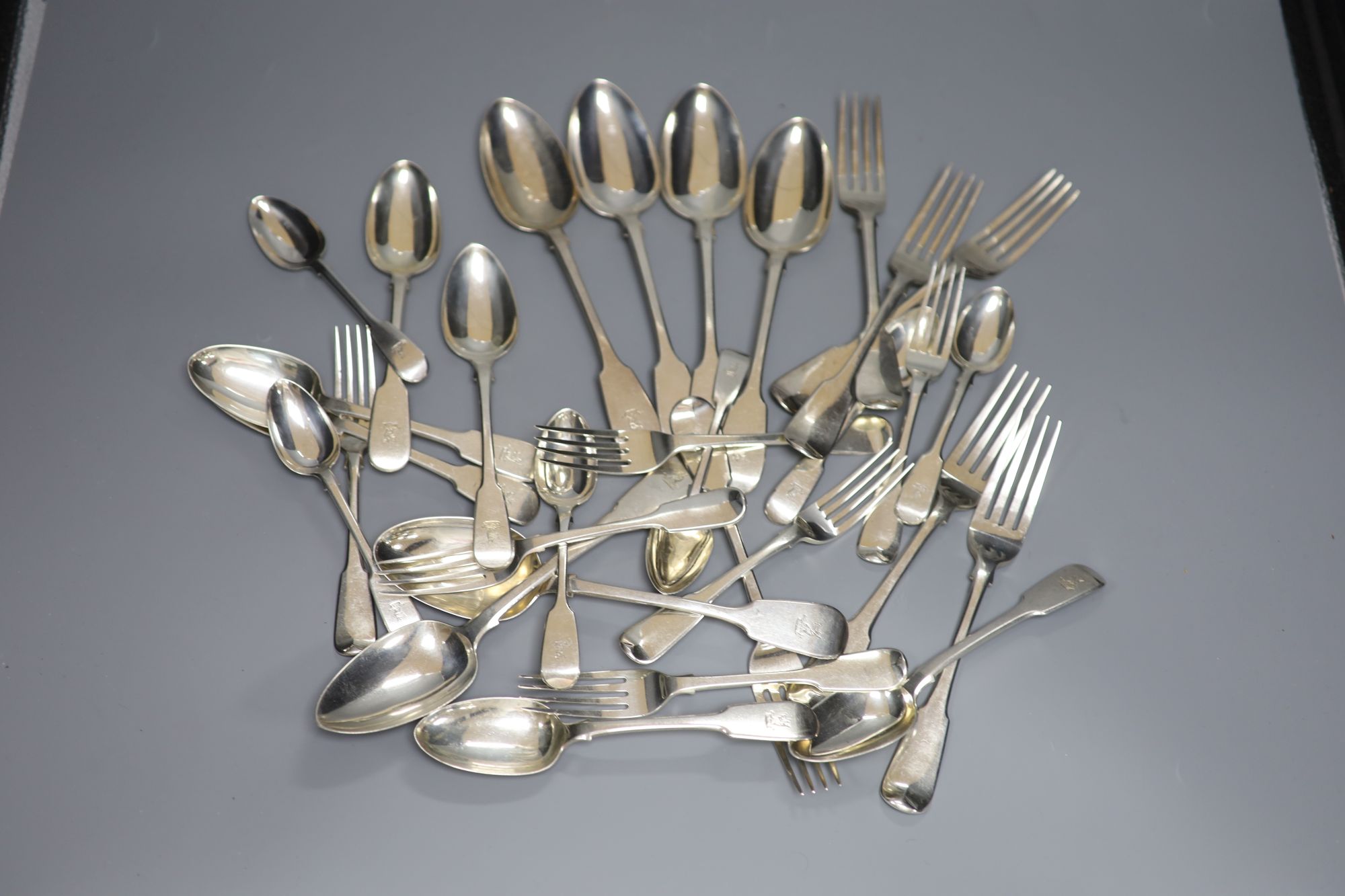 A harlequin set of George III and later silver crested fiddle pattern flatware, 50oz
